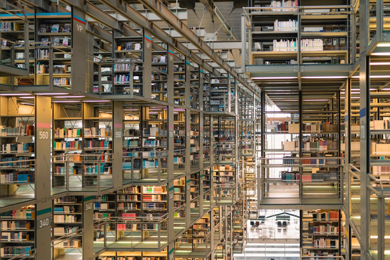 Rows of bookshelves in a modern library in Mexico City, showcasing a vast collection of books.